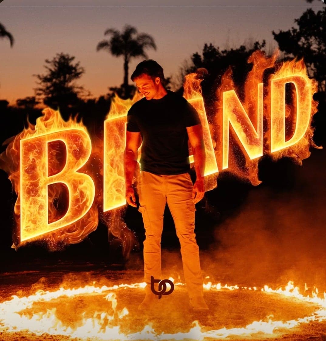 Brand single cover, the title in flames around the artist
