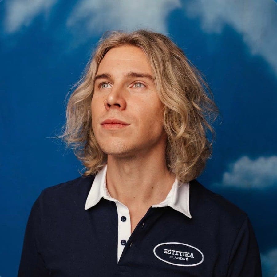 Cover artwork, a long-haired singer against blue sky