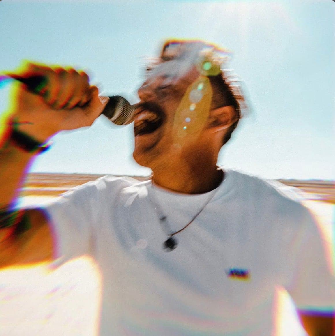 Cover artwork, a singer at the mic in bright sun