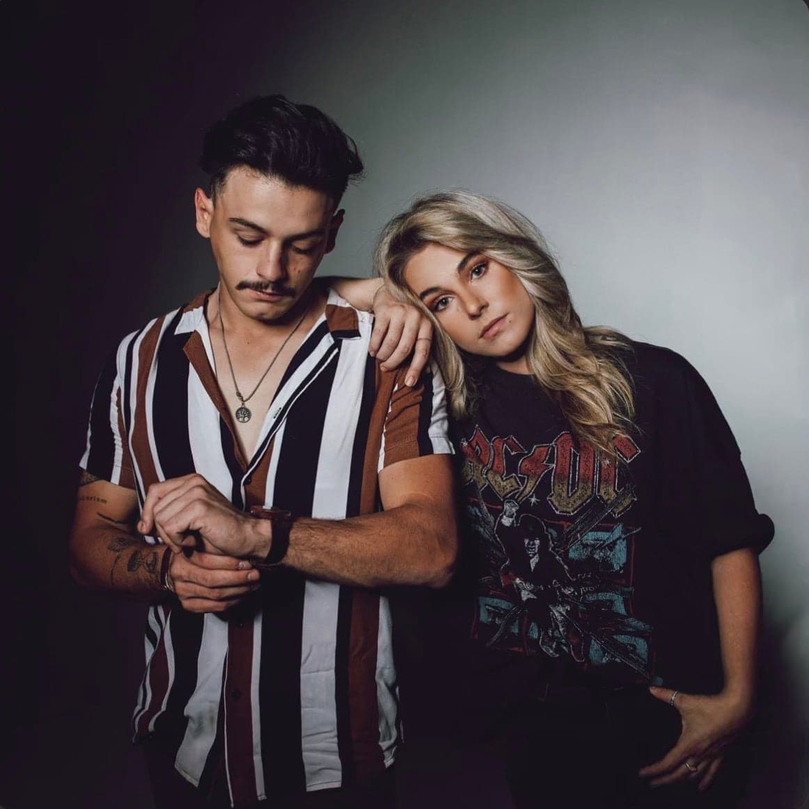Cover artwork, a duo against a grey wall