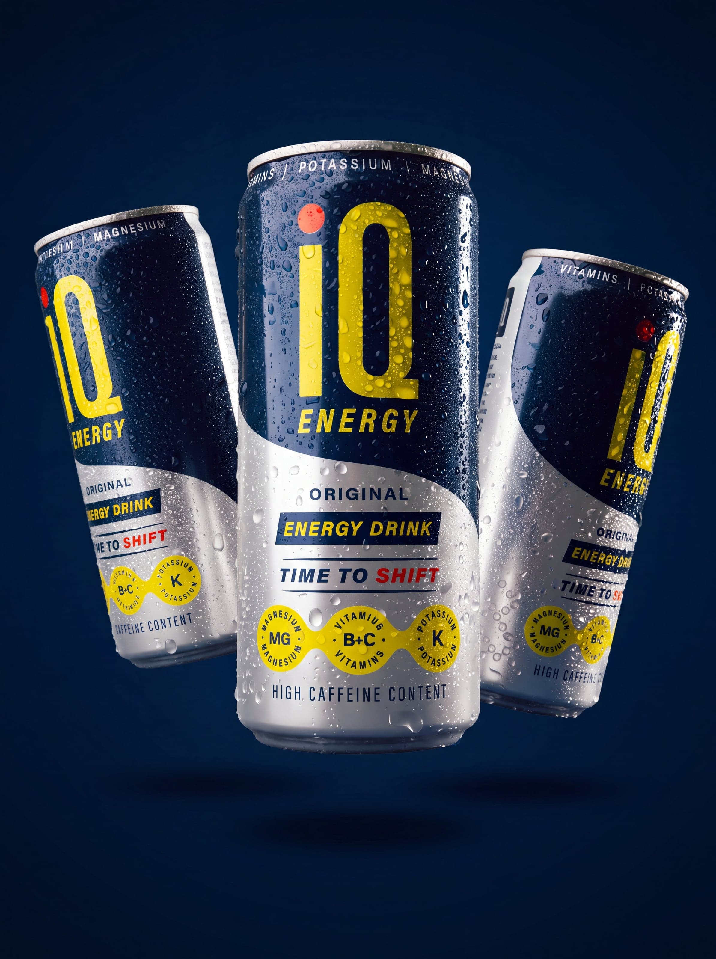 Three IQ Energy cans on deep navy