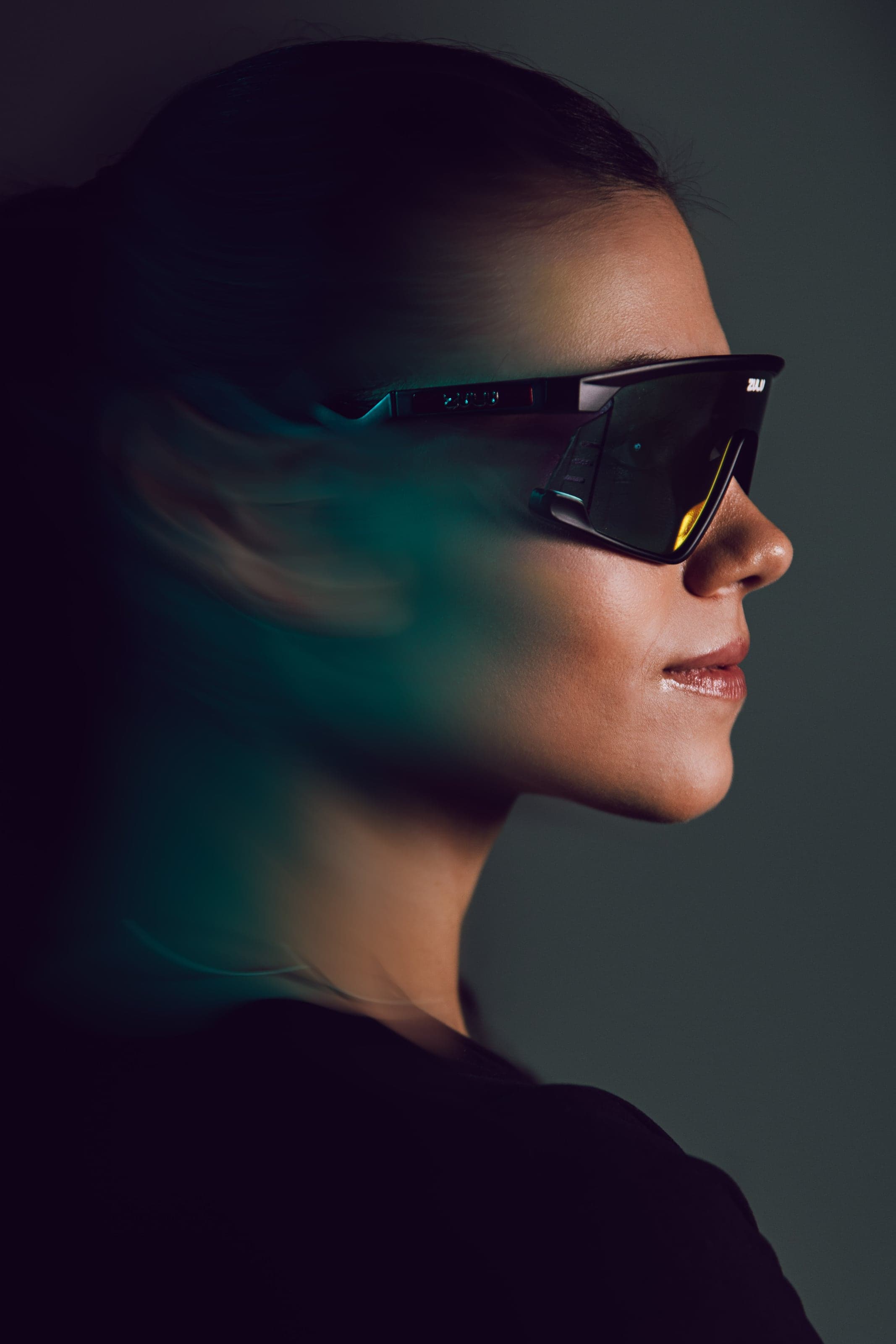 Profile in sports glasses with a cyan streak